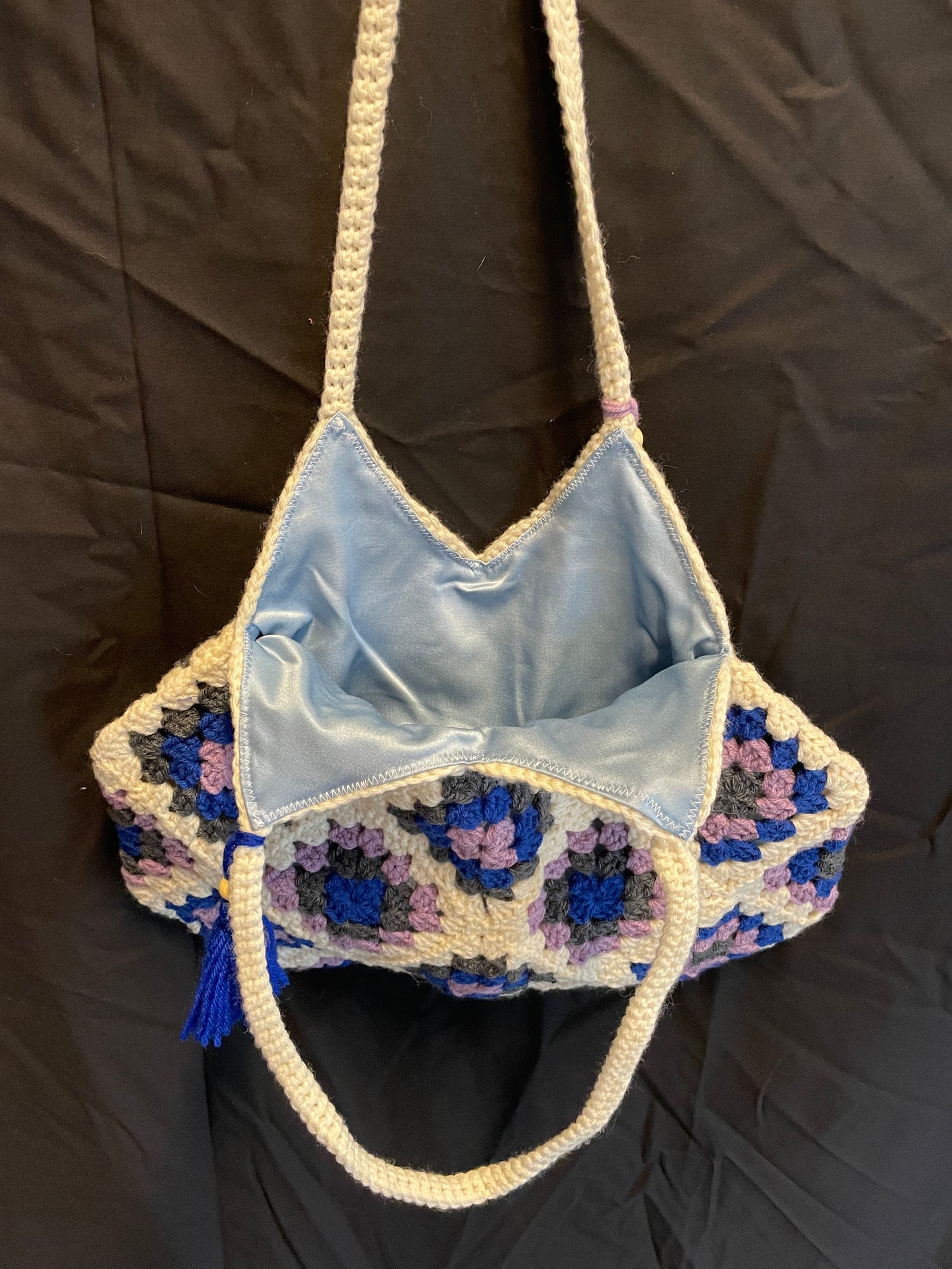 The Royal Elsa crochet Granny Square purse. Made with Upcycled materials for the perfect combination of retro, regal, & sustainable fashion