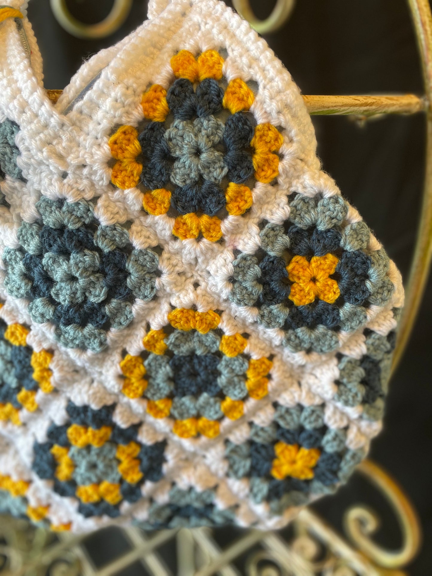 Farmhouse style, eco-friendly crochet granny square purse. 70s vintage charm featuring upcycled materials and stylish sustainable design