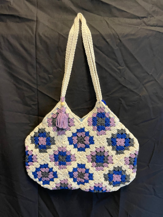 The Royal Elsa crochet Granny Square purse. Made with Upcycled materials for the perfect combination of retro, regal, & sustainable fashion