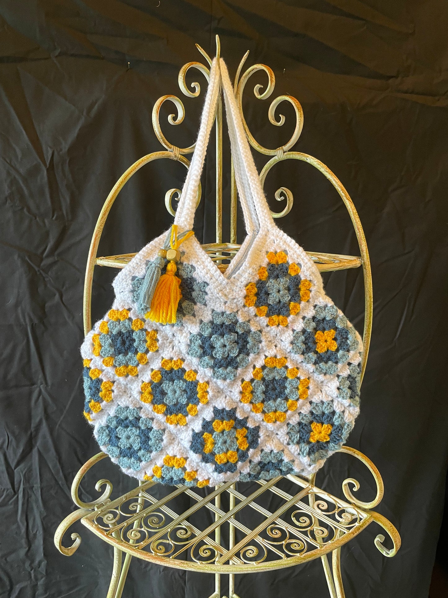 Farmhouse style, eco-friendly crochet granny square purse. 70s vintage charm featuring upcycled materials and stylish sustainable design