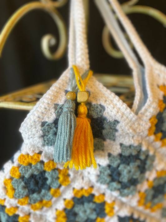 Farmhouse style, eco-friendly crochet granny square purse. 70s vintage charm featuring upcycled materials and stylish sustainable design